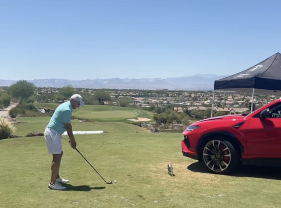 Tee shot over a desert valley course