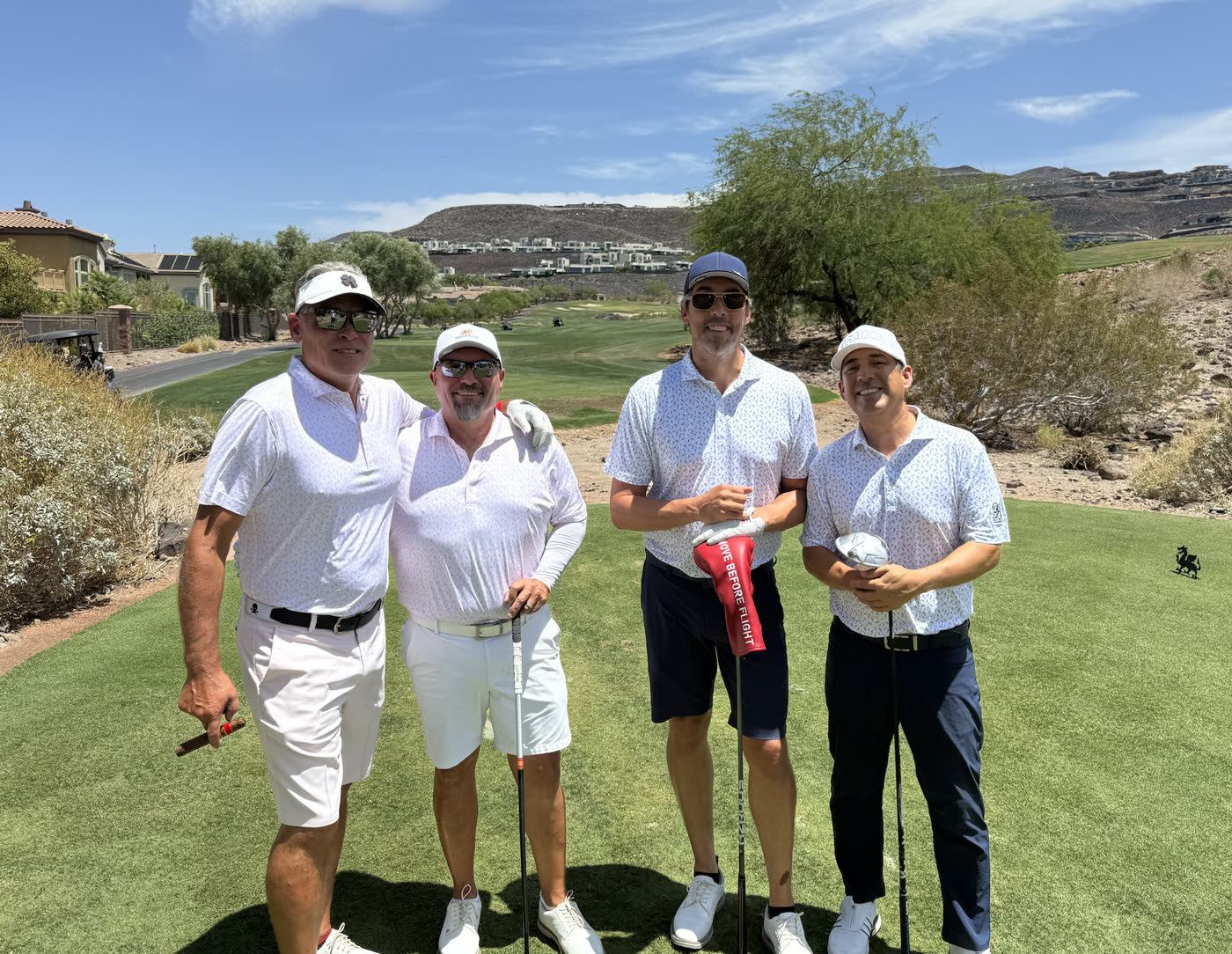 Foursome of golfers on a desert course